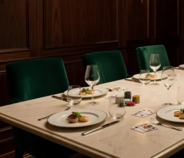 Private dining room styled for a casino-themed dinner with emerald and gold décor