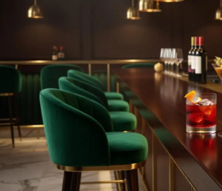 Signature cocktails and wine glasses on a marble bar with gold detailing