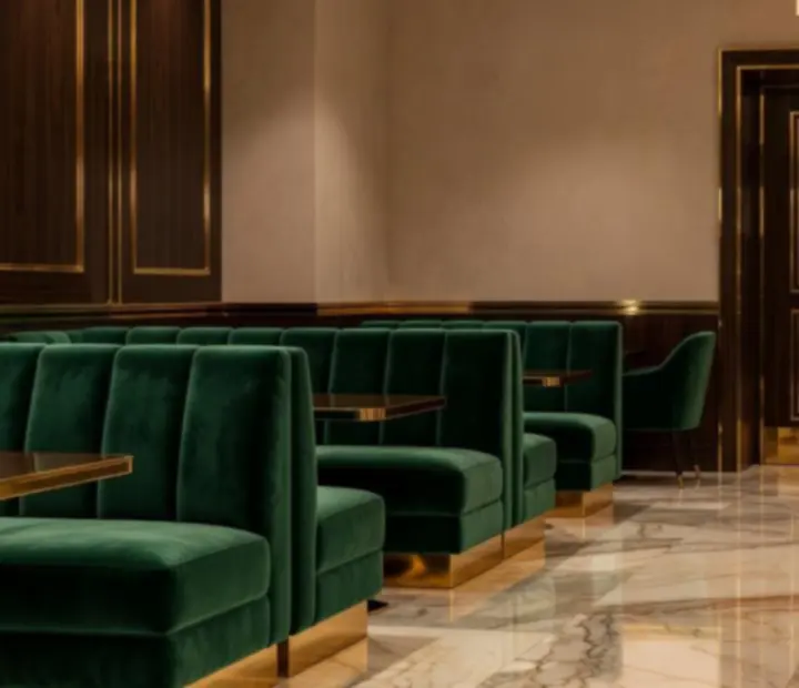 Emerald velvet entrance seating with gold detailing at Wonderstar s. r. o.